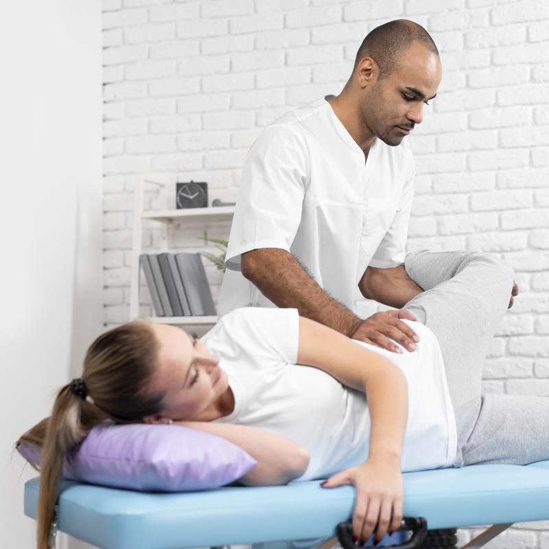 Male Physiotherapist Checking Woman S Hip